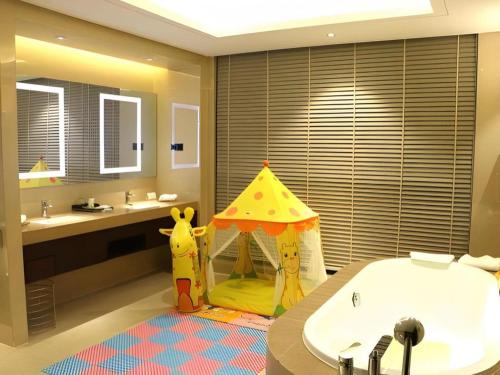 a bathroom with a tent in the middle of a tub at New Century Grand Hotel Xi'an Xizang Building in Xi'an