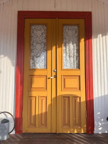 a yellow door with two windows on a house at Solberg Inn 