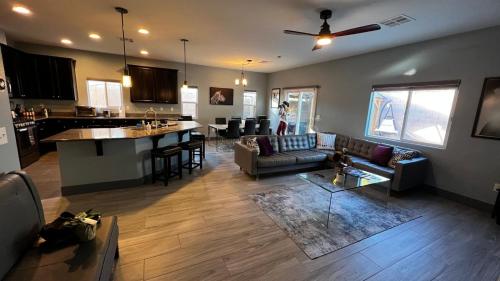 a living room with a couch and a table and a kitchen at Family Friendly Contemporary House with Pool in Las Vegas