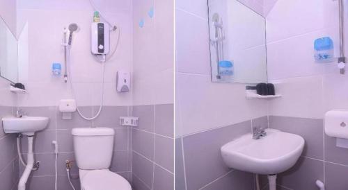 a bathroom with a toilet and a sink at OYO 89465 Golden Lounge in Kuching