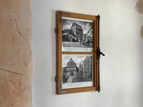 a framed picture of a building on a wall at Emma Häusle in Sommerhausen