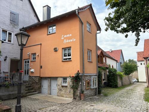 an orange building on a cobblestone street at Emma Häusle in Sommerhausen