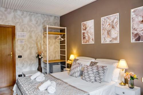 a bedroom with a bed with white sheets and pillows at Di Martino Residence in Rome