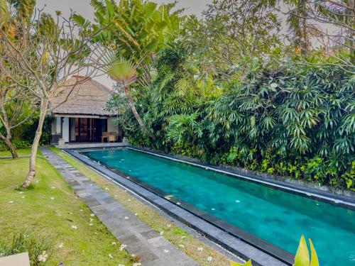 a swimming pool in front of a villa at Villa Blubambu in Seminyak