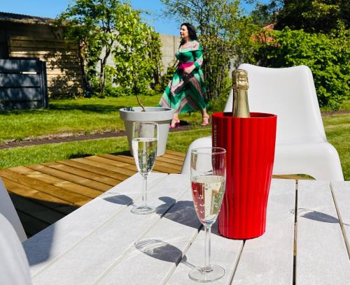 a bottle of champagne and two glasses on a table at BEEEP Stay in Hasselt