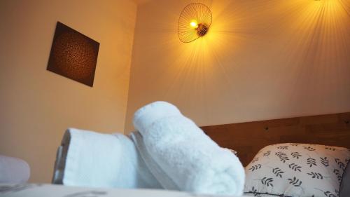 a teddy bear laying on a bed in a room at L'Embellie in Gagnac-sur-Cère