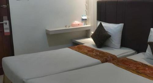 Postel nebo postele na pokoji v ubytování Jelita Tanjung Hotel