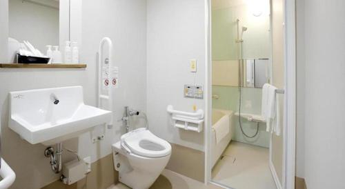 a bathroom with a sink and a toilet and a shower at Hotel Sunoak Kashiwanoha in Kashiwa