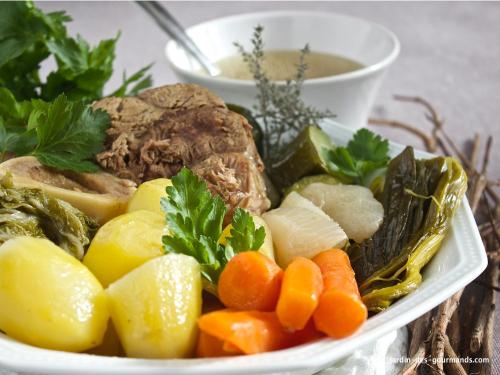 a plate of food with meat and vegetables and a bowl of soup at Nebespán in Kašperské Hory