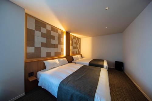 Cama o camas de una habitación en GRAND BASE Kurashiki Chuo