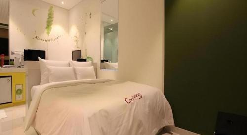 a bedroom with a white bed in a room at Crossing Hotel in Seoul