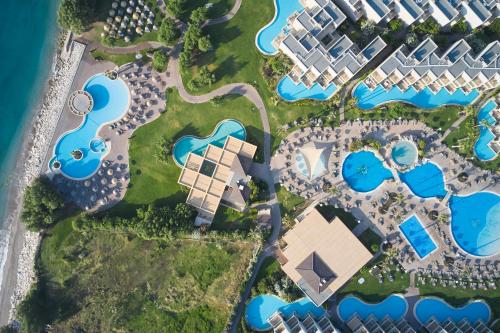 an aerial view of a resort with swimming pools at Atlantica Aegean Blue in Kolimbia