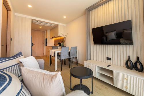 a living room with a couch and a bed at The Ozone Residences Bangtao in Phuket