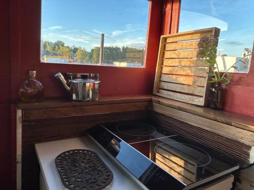 a stove top oven in a kitchen with a window at Hebergement insolite Boat Near Paris in Thourotte