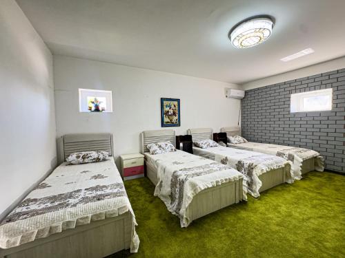 Ένα ή περισσότερα κρεβάτια σε δωμάτιο στο Casa Uzbek