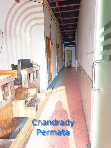 a hallway of a building with a couch in the middle at Chandrady Permata Guest House 2 in Jakarta