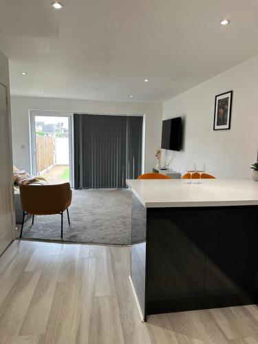 a kitchen with a counter and a living room at The Mayfair Residence