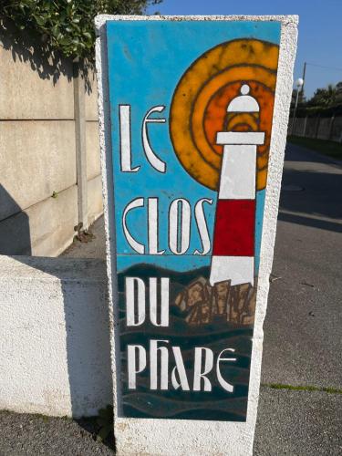 a sign with a lighthouse on the side of a street at Maison le clos du phare 3 in Quiberon