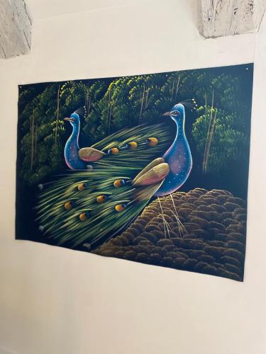 a painting of three peacocks on a plant at Les Carillons du Bois de l'Orme in Les Pechs-du-Vers