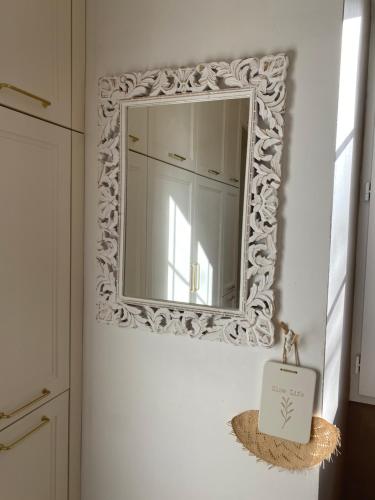 a mirror on a wall in a bathroom at Les Carillons du Bois de l'Orme in Les Pechs-du-Vers