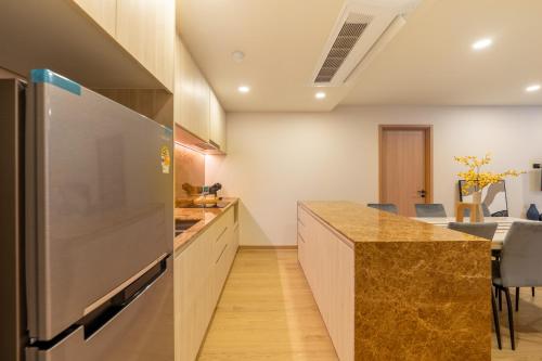 a kitchen with a stainless steel refrigerator and a counter at The Ozone Residences Bangtao in Phuket