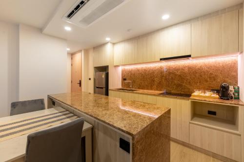 a large kitchen with a counter and a table at The Ozone Residences Bangtao in Phuket