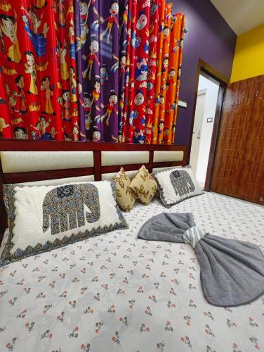 a bedroom with a bed with a bow tie on it at Aashray Independent Homestay Dibrugarh in Dibrugarh