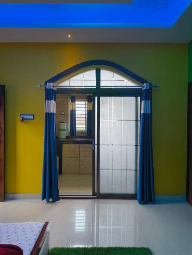 a room with an open door to a kitchen at Aashray Independent Homestay Dibrugarh in Dibrugarh