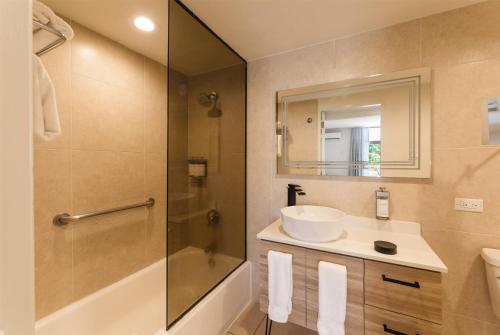 a bathroom with a sink and a shower at Wyndham Palmas Beach and Golf Boutique Resort in Humacao
