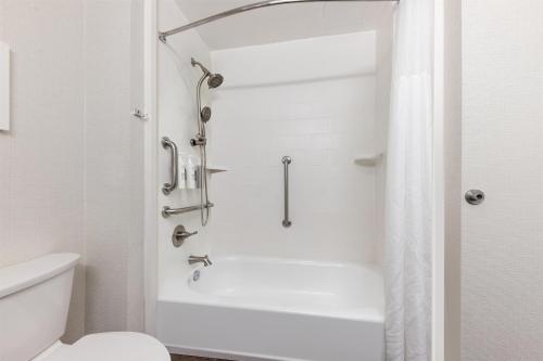 a white bathroom with a shower and a toilet at Hampton Inn Phoenix Midtown Downtown Area in Phoenix