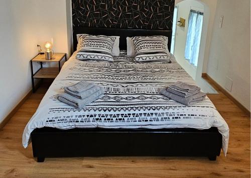 - un grand lit avec des oreillers dans la chambre dans l'établissement Bel appartement et son jardin, à Saint-Cézaire-sur-Siagne