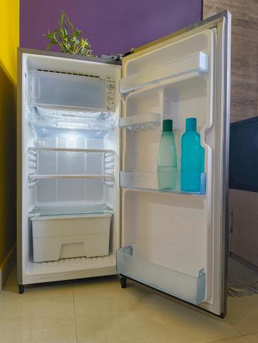 an open refrigerator with two milk bottles in it at Aashray Independent Homestay Dibrugarh in Dibrugarh