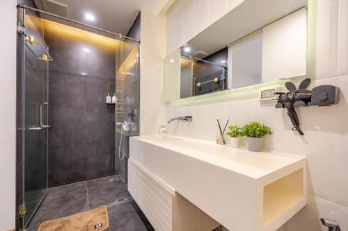 a bathroom with a sink and a shower at The Nimmana Condo 410 - Super Deluxe 1BR Balcony extension in Chiang Mai