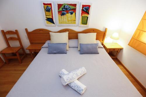 a room with a bed with two ties on it at FLORA Apartment in Cambrils
