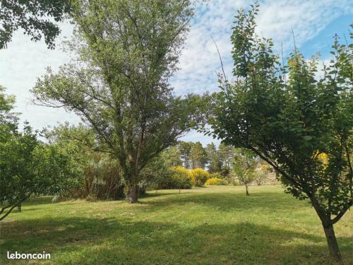 a field with trees in a park at Gite de la Colline - 3 pers in Solérieux