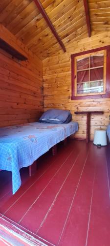 a room with a bed in a wooden cabin at La Cort & Căsuțe Camping Adults Only in Vama Veche