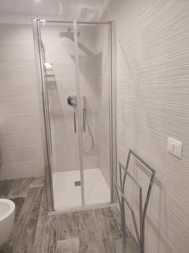 a shower with a glass door in a bathroom at Il canto del mare in Giovinazzo