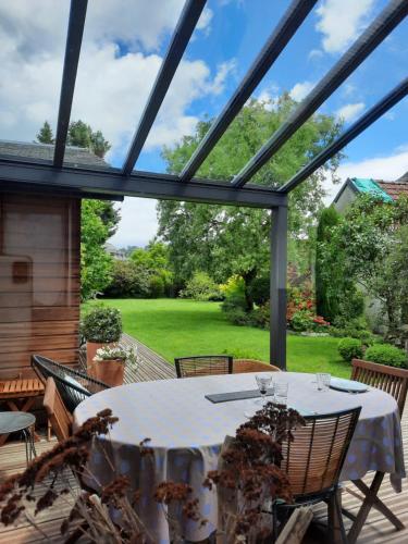 a conservatory with a table and chairs on a patio at Tiny House in Pontacq