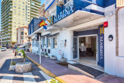 a blue and white building on a city street at Hotel Marina in Oropesa del Mar