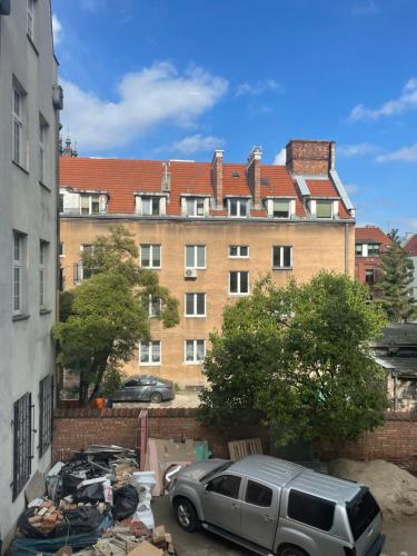 a car parked in a parking lot in front of a building at Luxury Apartments Gdansk in Gdańsk