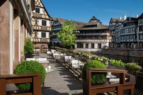 a courtyard with tables and chairs in a building at Hotel & Spa REGENT PETITE FRANCE By Stay Collection in Strasbourg