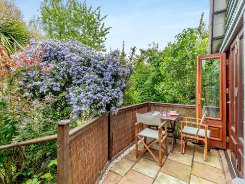 a patio with a table and chairs on a fence at Bryanstown Annexe in Woodbridge