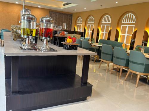 a bar in a restaurant with a table and chairs at Anandi Bhawan by Paandora in Chhatikara
