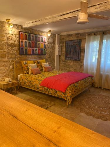 a bedroom with a large bed in a room at Les Carillons du Bois de l'Orme in Les Pechs-du-Vers