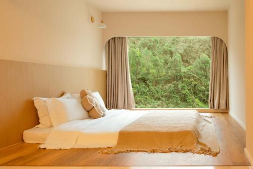 Postel nebo postele na pokoji v ubytování AKANARA · Yangchou Paradise Resort