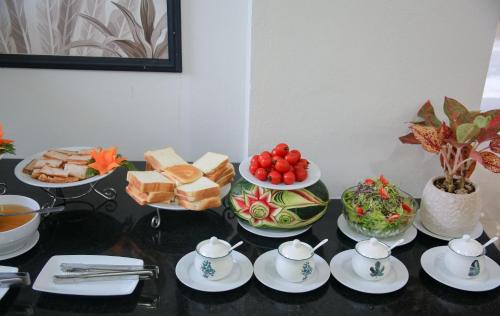 a table topped with plates and bowls of food at Khách sạn Đại An Ninh Bình in Ninh Binh