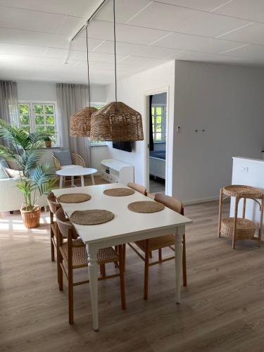 a white table and chairs in a living room at Svalereden Strand Camping Apartments in Frederikshavn
