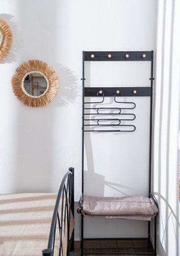 a metal stair case with a mirror on the wall at Amalia Luxury Room in Kalamaki Heraklion