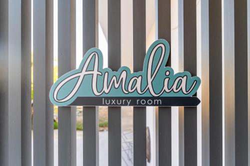 a sign that reads antilla luxury room on a fence at Amalia Luxury Room in Kalamaki Heraklion