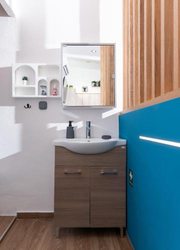 a bathroom with a sink and a mirror at Amalia Luxury Room in Kalamaki Heraklion